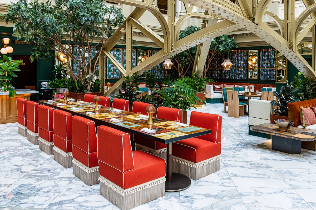 a restaurant featuring red chairs and tables